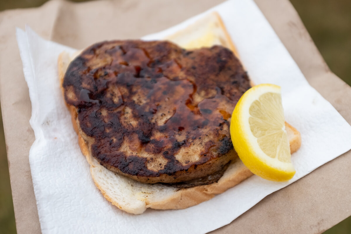 A Hakari Kai Kart mussel fritter on white bread. Photo: Alex Blackwood
